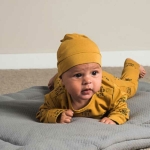 Een set van 2 okergele knoopmutjes. Het ene mutsje is effen van kleur en het andere mutsje heeft een print met de tekst 'I have a Wild Side'.