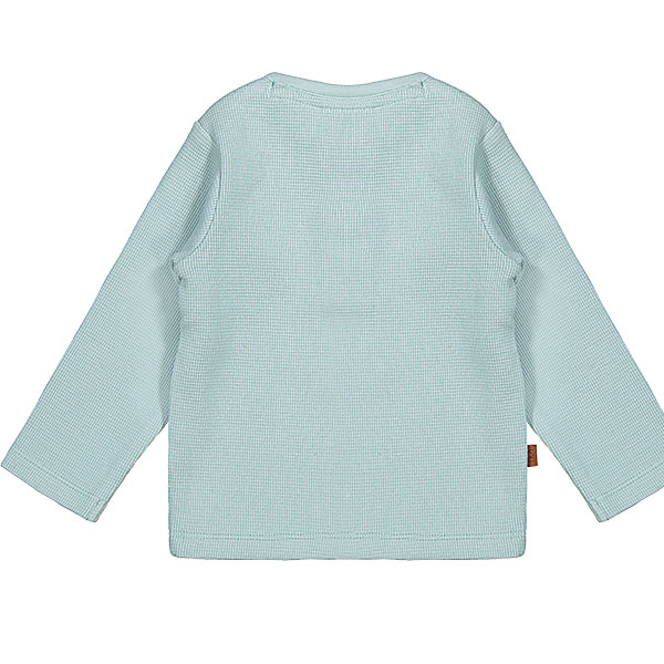 Dit stoer shirtje Waffle met lange mouw in de kleur blauw komt uit de collectie Polar Adventure van Frogs and Dogs. Het shirtje is effen van kleur en is gemaakt van zachte wafelstof. Aan de voorzijde zit een sluiting met 2 drukkers.