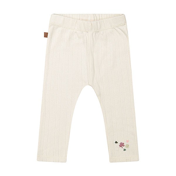 Deze mooie gebroken witte legging komt uit de Spring Lucky collectie van Frogs and Dogs. De legging is gemaakt van zachte stof met gebreide gaatjes. Aan de linker voorzijde, onderaan, zitten geborduurde bloemetjes & hartjes. De legging heeft een elastische banden de pijpjes zijn gezoomd.
