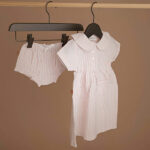 Dit schattige poeder roze jurkje komt uit de Spring Breeze collectie van Frogs and Dogs. Het jurkje is gemaakt van zacht katoen en is gemaakt van gestreepte stof in de kleuren poeder roze & wit. De hals is afgewerkt met een leuk kraagje en aan de voorzijde zitten een aantal knoopjes. Het jurkje heeft korte mouwen hebben een gezoomde rand. Op de voorzijde van het jurkje zitten 2 zakjes.