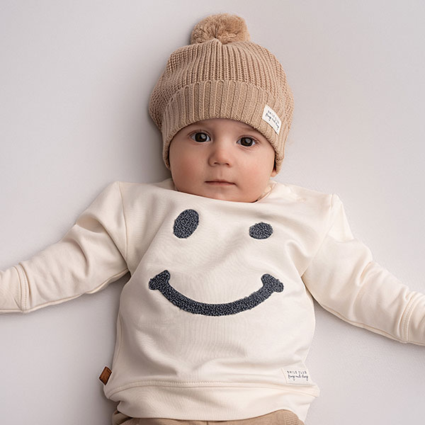 Deze stoere sweater in de kleur beige komt uit de Smile Club collectie van Frogs and Dogs. De sweater is gemaakt van zacht katoen. Op de voorzijde is het hoofdje van een 'Smile' geborduurd met wollige blauwe garen waardoor het er echt op ligt. Aan de binnenzijde is vlies gebruik waardoor de huid van je kleintje beschermd wordt.