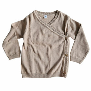 Dit mooie gebreide overslagshirtje met lange mouw is in de kleur cappuccino en komt uit de collectie Simply Nice Girl van Frogs and Dogs. Het shirtje heeft een mooie overslag. De overslag heeft een gebreid rufflerandje. De boordjes zijn gebreid.