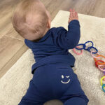 Stoere blauwe baby sweater met kleine smiley op borsthoogte voor een vrolijke touch. Gemaakt van zacht en warm materiaal, perfect voor frisse dagen.