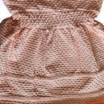 Dit lieve Bubble jurkje in zalmroze komt uit de Summer Flowers-collectie van Frogs and Dogs. Het jurkje is mouwloos en heeft schouderbanden. De elastische tailleband van dezelfde stof zorgt voor een mooi getailleerd effect. Aan de onderzijde van het rokje zijn twee stukjes kant gestikt. Gemaakt van een luchtige stof met een speels bubbeltjespatroon. Perfect voor een zomerse, schattige look!