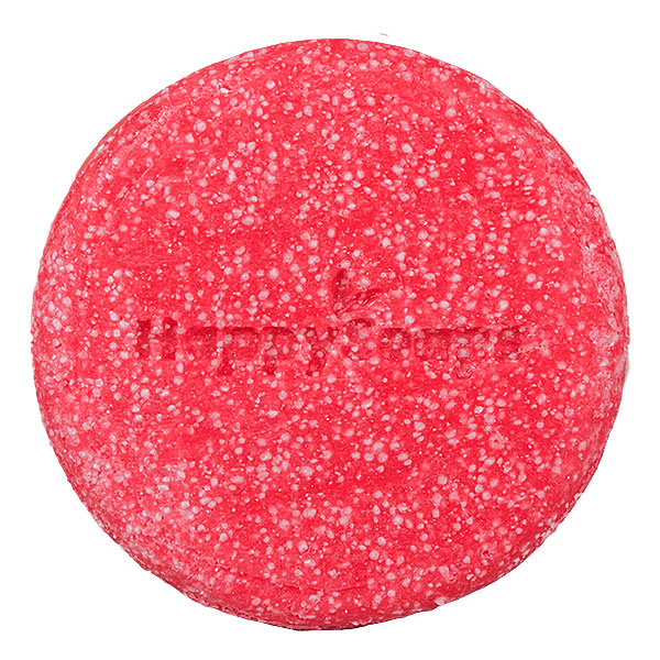 Happysoaps You’re One in a Melon Shampoo Bar in roze kleur met verpakking op roze achtergrond.