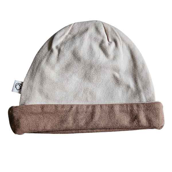 Tweedehands babymutsje Studio Spruitje poederroze met beige omslagrand