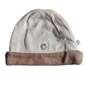 Tweedehands babymutsje Studio Spruitje poederroze met beige omslagrand